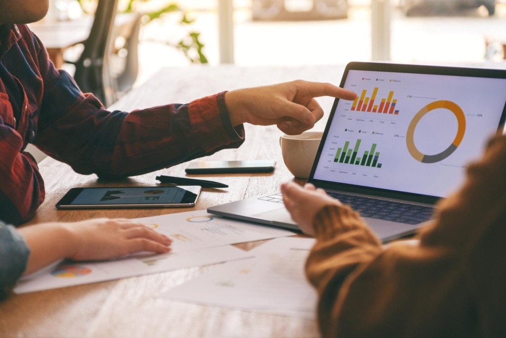 Three businessman working and discussing business and reporting charts together in a meeting